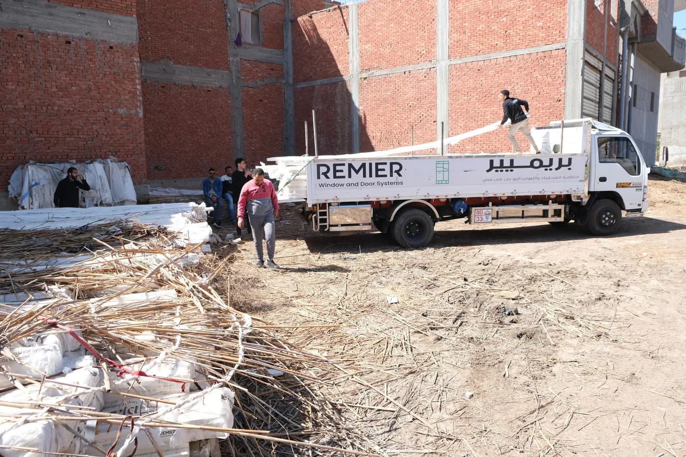 Premier-branded truck delivering profiles at a client site