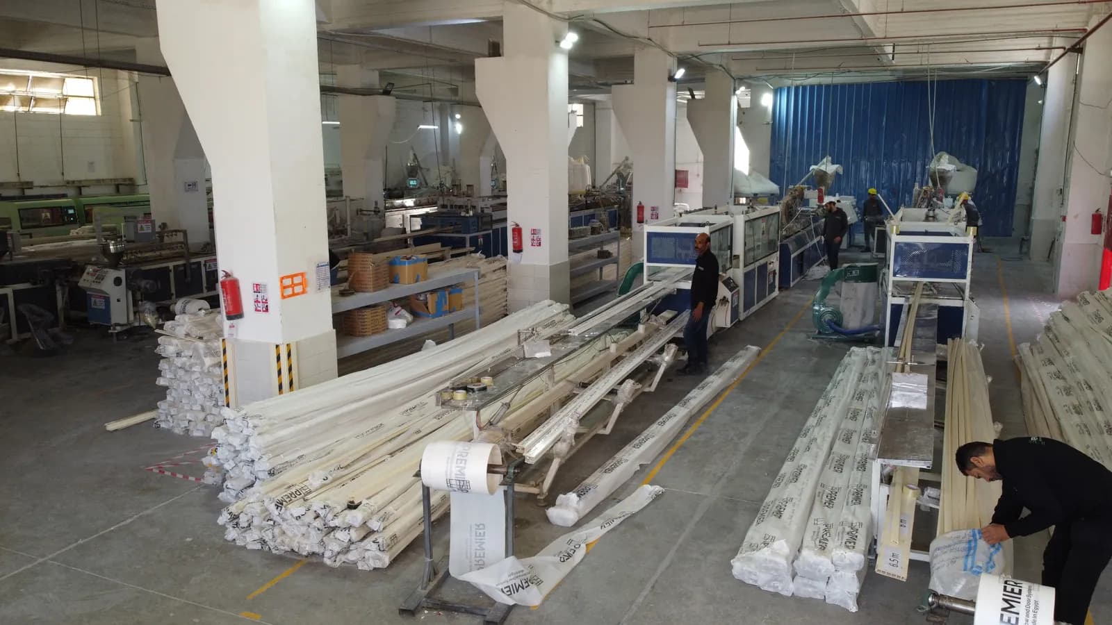 Indoor aerial of the extrusion hall — production lines and Premier-wrapped profiles
