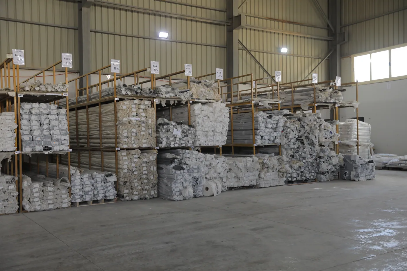 Finished-goods warehouse — racked, wrapped profiles